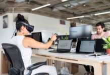 woman using laptop computer with vr headset