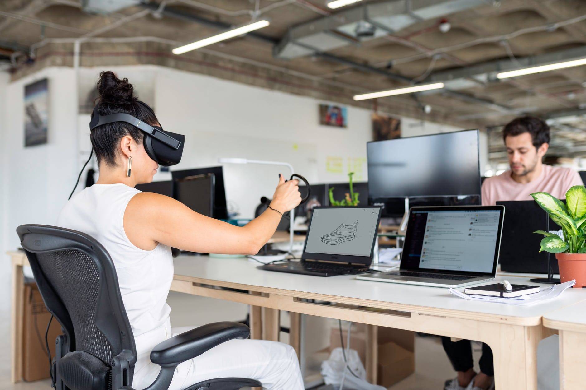 woman using laptop computer with vr headset