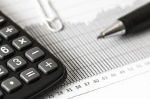 How to Get Accounts Job in Dubai on Visit Visa calculator and pen on table
